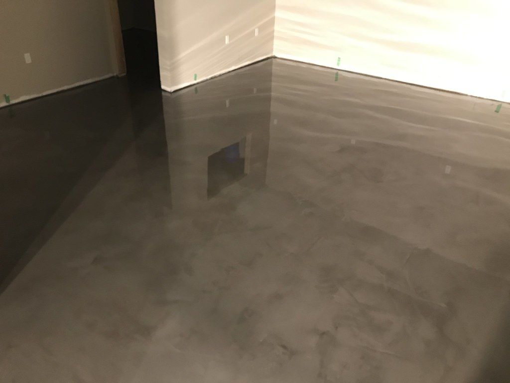High-gloss metallic epoxy floor with silver marbleized finish in Sioux Falls